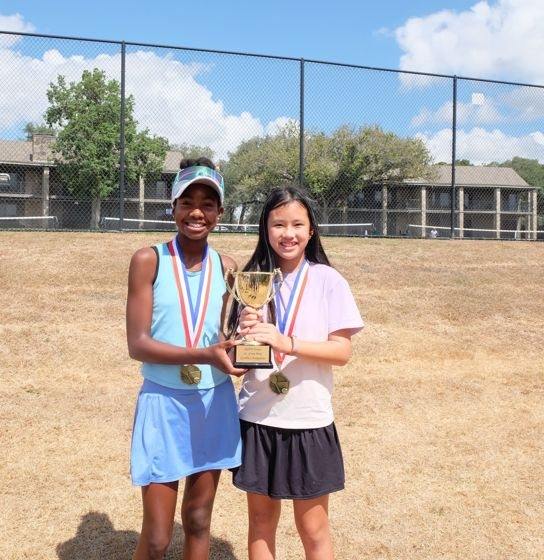 Two Junior Gran Prix finalists with the trophy