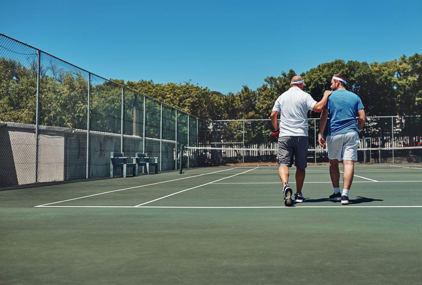 Two players walking off a Houston public court together after a match
