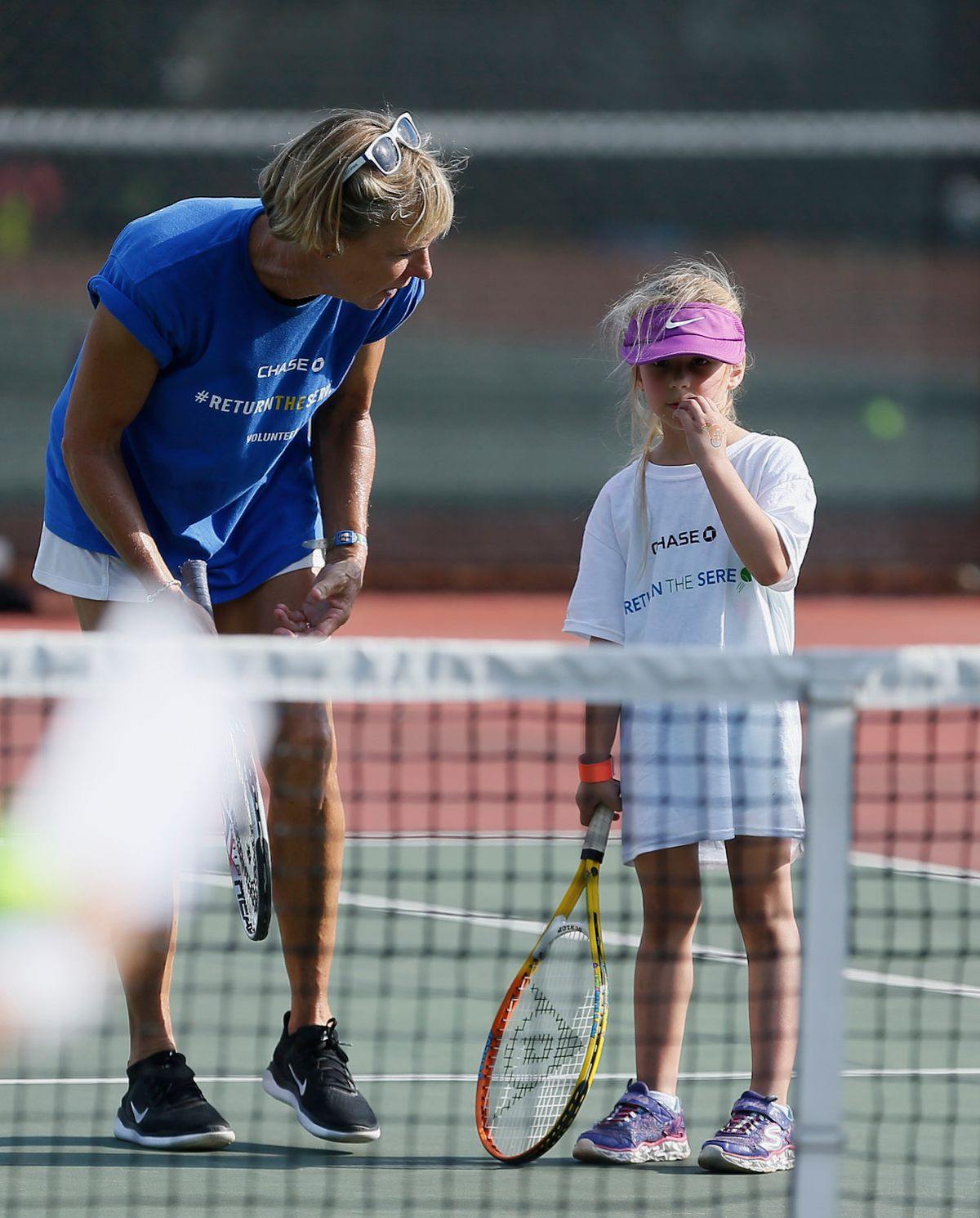 A coach working one-on-one with a young player