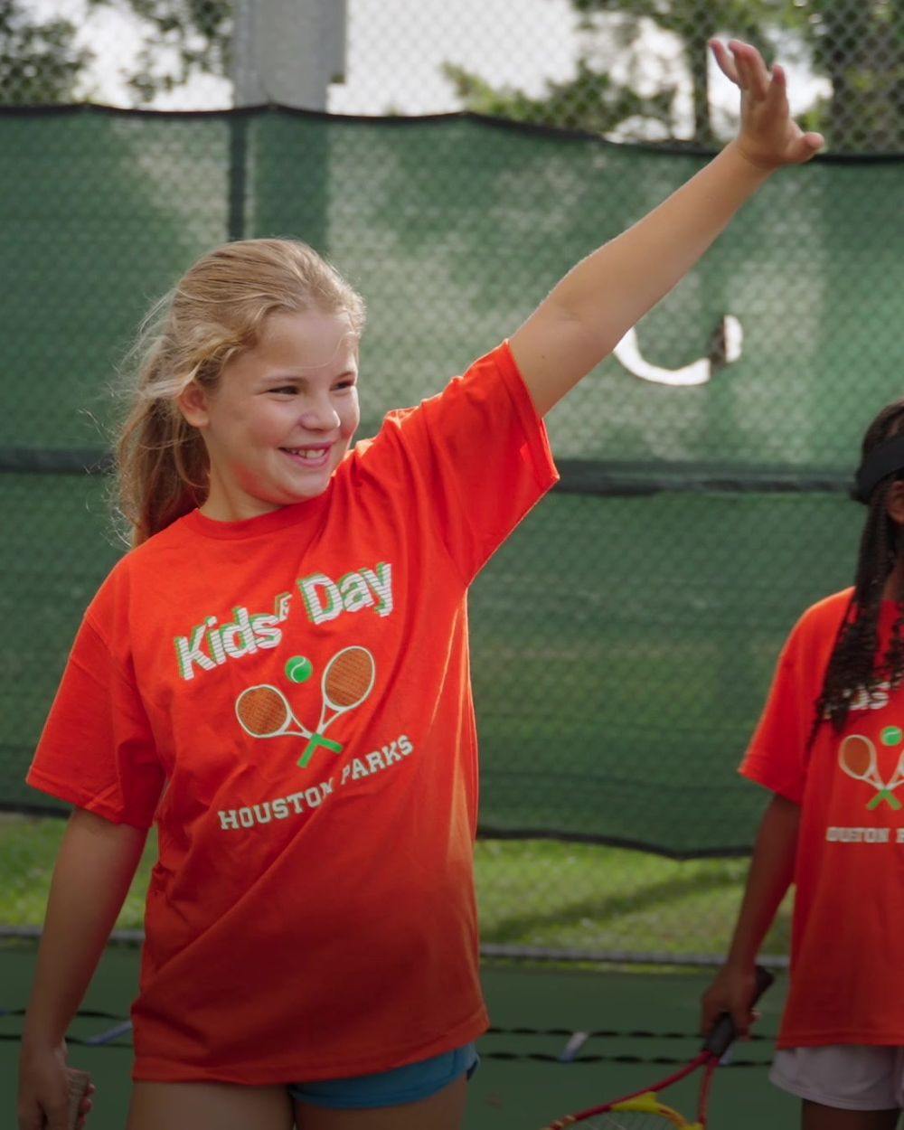 A young player serving at Houston NJTL Kids&rsquo; Day